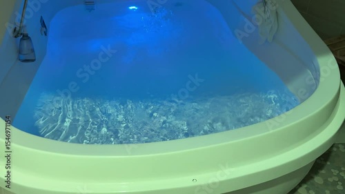 A video shows a bluelit floatation therapy pod, creating serenity