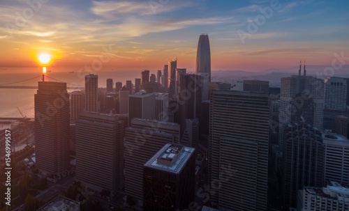 Sunrise over San Francisco, California, USA. The sun rises over the Bay Bridge, illuminating the city skyline with the Salesforce Tower as a focal point.
