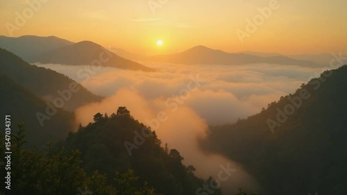 Sunrise Over Mountain Range with Clouds Filling Valley