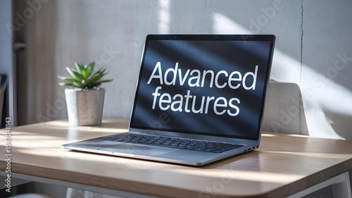 Modern Laptop Displaying “Advanced Features” on Contemporary Desk with Green Plant – Software Innovation and Productivity Concept