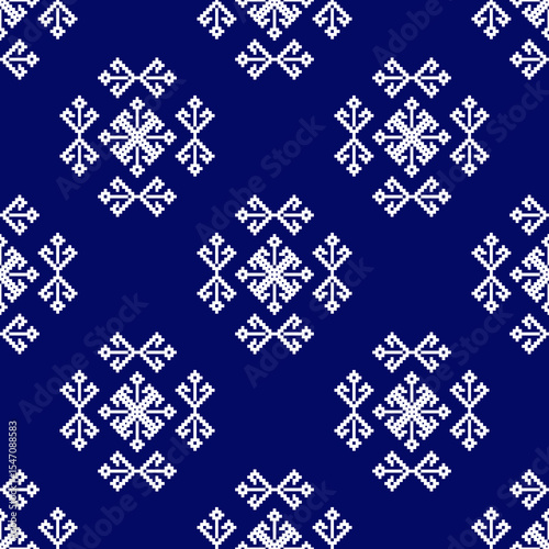Cross-stitch seamless pattern on a blue background. Ukrainian traditional embroidery. Boho style. Tribal pattern. Vyshyvanka. Pixel art. Ideas for wallpaper and textiles. 