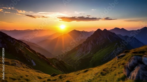 Spectacular mountain range at golden hour with vibrant sun rays shining through serene mountain peaks and valleys, showcasing natural beauty