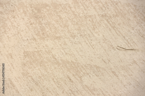 Mottled speckled tan, beige and brown close-up abstract textured background