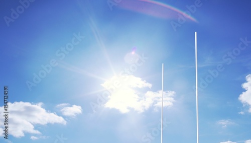 Two white goal posts are rising into flat design sky with sun lens flare behind cloud