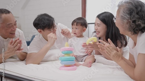 Family enjoys playtime with toddler using colorful stacking rings in a cozy indoor setting
