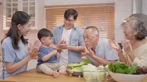 Family gathers in kitchen to enjoy cooking and playful moments together
