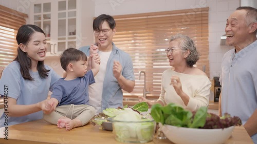 Family enjoys cooking together in a bright kitchen while having fun
