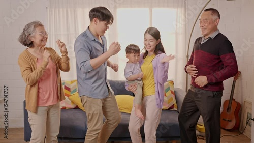 Family members joyfully dancing together in cozy living room during afternoon