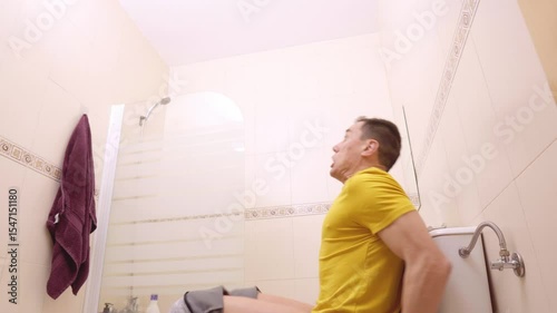 Man runs like crazy into the bathroom and sits down