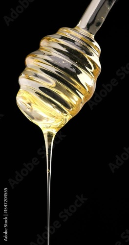 pure real honey drizzling capturing the rich texture and natural golden glow of this pure, organic sweetener