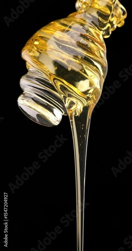 close-up of real honey dripping from a glass dipper, ideal for themes of organic food, natural sweetness, and slow living