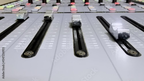 A slide fader was moving of a sound mixer panel control.