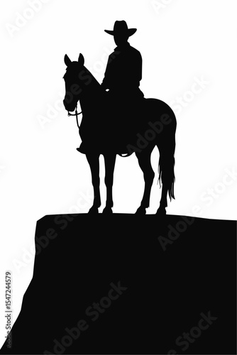 A cowboy is astride his horse on a rocky bluff in silhouette


