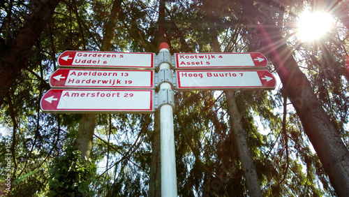 Bicycle signpost in the Netherlands at the crossroads N344 and N302. It shows the bicycle direction to Amersfoort, Apeldoorn, Harderwijk and more