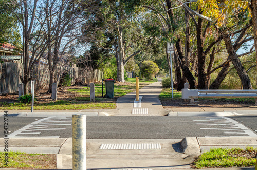 Tablou pe pânză A suburban pedestrian crossing features a speed bump on the road to slow down vehicles, enhancing safety for pedestrians and cyclists, allowing for safe access to the street in Melbourne, Australia