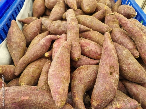 Organic raw purple sweet potatoes from local farmer market in basket. Sweet Potato (Ipomoea batatas), ubi, purple yam good source of antioxidants, particularly anthocyanins, which are linked to variou