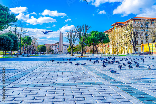 Pigeons on Sultanahmet square and the obelisks in background, Istanbul, Turkey photo