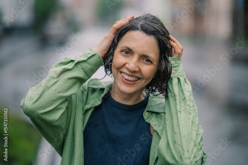 Smiling woman outdoors in rainy city portrait
