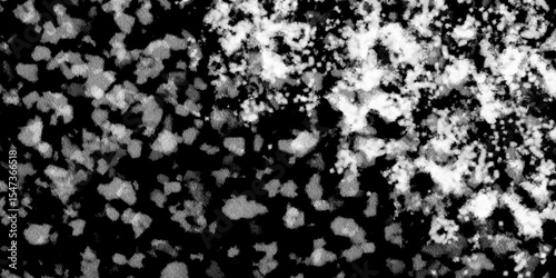 Snowflakes on dark background. white icy snowflakes isolated on black background, natural background. white crystalline powder on a black background. sugar dust. texture, pattern and clipping.