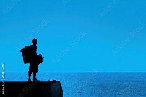 A man stands on a pier with a backpack and a golf bag. Silhouette set against a striking blue horizon embarking on a journey beyond imagination.