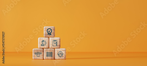 Wooden blocks with quality management, safety, checklist, and engineering icons in pyramid shape on orange background. Concept of industrial standard and process control.