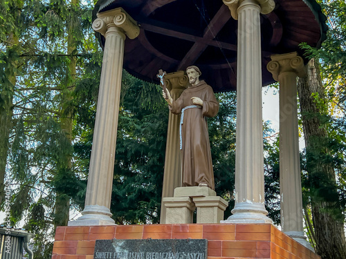 Statue of St. Francis in the garden at the Minor Basilica of Our Lady of Listening Patiently in Rokitno, Poland photo