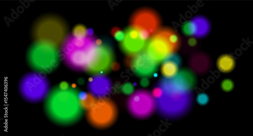 Multicolored glowing circles on dark background. Blurred soft shapes of various sizes create abstract festive atmosphere.