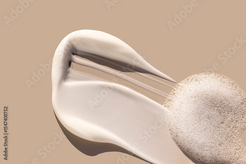 creamy texture of cosmetic samples on a pastel beige background