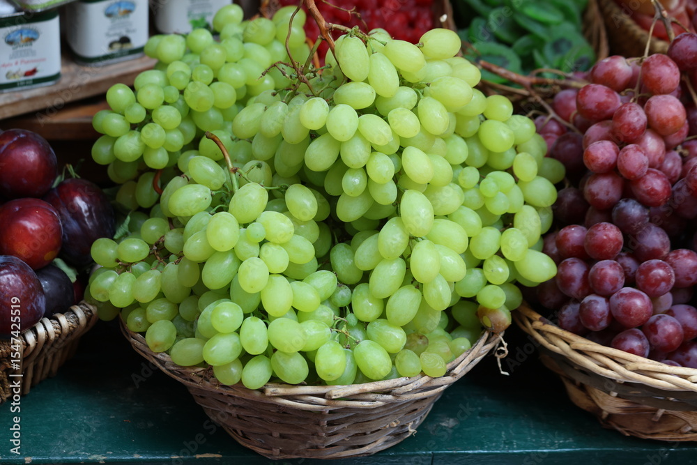 An assortment of fresh fruits in a wicker baskets on sale An assortment of fresh fruits in a wicker baskets on sale