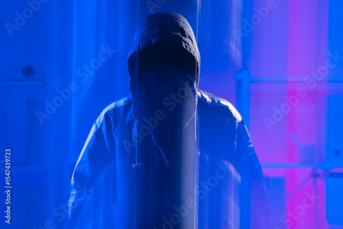 Mysterious Figure in Hoodie Symbolizing Cybersecurity Threats