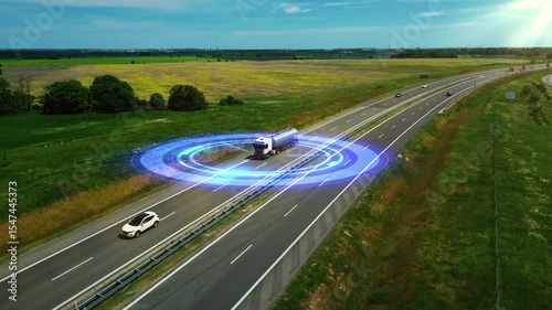 High-tech truck drives along a highway surrounded by glowing digital radar rings, symbolizing autonomous driving, unmanned vehicle technology, GPS tracking, and the future of smart transportation. 