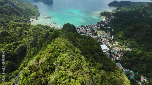 Wallpaper Mural Stunning high-altitude drone view reveals El Nido town nestled between lush tropical hills and a turquoise bay filled with boats. A unique panorama blending wild nature and human life in Palawan. Torontodigital.ca