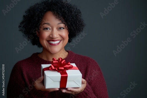 Happy Woman Holding a Gift, Joyful Expression, Festive Season