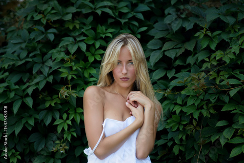 Outdoor portrait of beautiful young woman with green eyes at summertime.