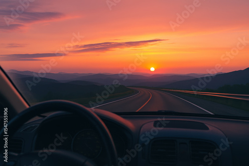 Sunset road view from car with mountain silhouette and colorful sky