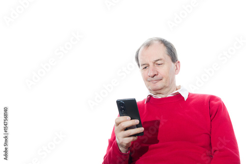 Portrait of a sixty-year-old man in a red pullover.