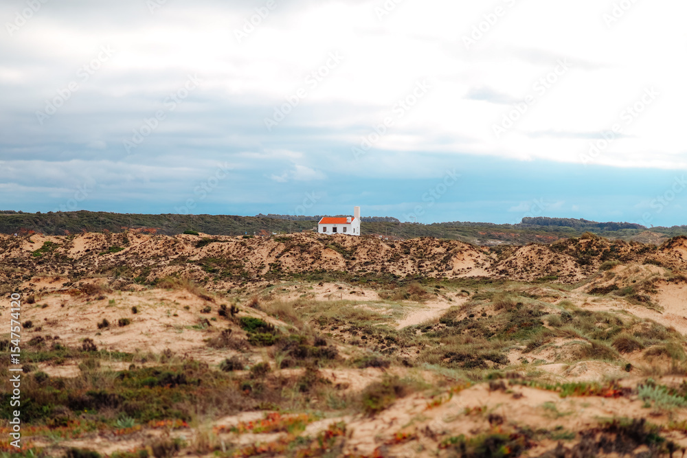 Fototapeta premium Lighthouse on the shore of the Atlantic Ocean in dramatic light