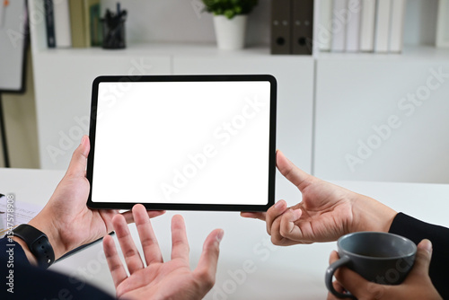 Close up of business team working analysis brainstorm together tablet blank white screen placed at office. Mock up.