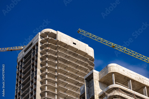 Tower cranes at the construction site. Construction crane on the background of the sky. Construction site.
