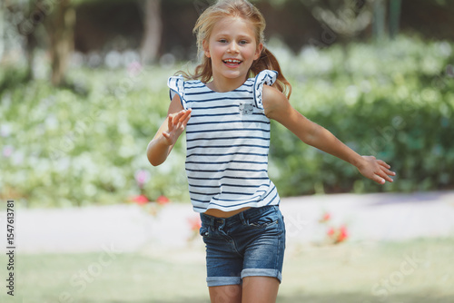 Joyful Girl Running in the Summer Park