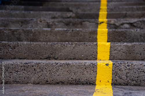 External stone stairs with yellow line perpendicular to the steps on the Azorean island of Santa Maria, Portugal.