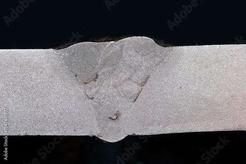 Weld macroetch sample. Cross-section reveals fusion zone, HAZ, inclusions, lack of fusion. Used in welding inspection, NDT training, metallography, and quality control evaluation.