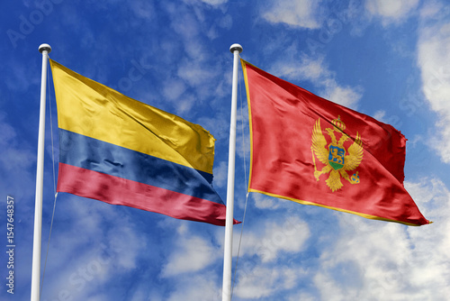 Colombian and Montenegrin flags proudly wave together, symbolizing international relations, friendship, and cultural exchange.