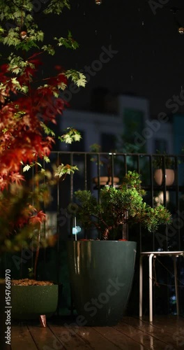 Summer thunderstorm. Night rain with flashing lightning on an open terrace in the city