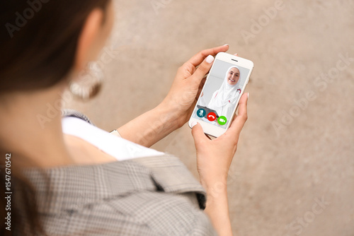 Young woman with mobile pho...