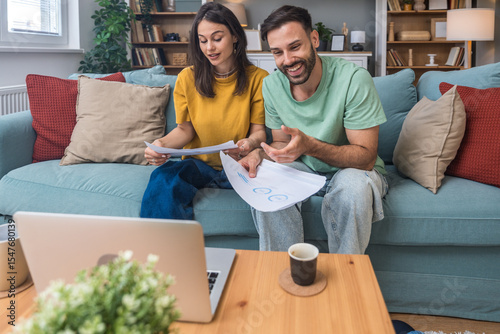 Successful young business people working together in home office. Freelance couple teamwork businessman and businesswoman startup concept video call presentation on laptop computer and webcam