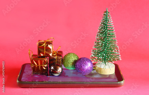 online shopping for christmas concept with christmas tree, decoration and smartphone