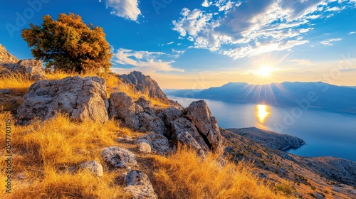Mountaintop sunset view rocky terrain golden grass tranquil sea landscape
