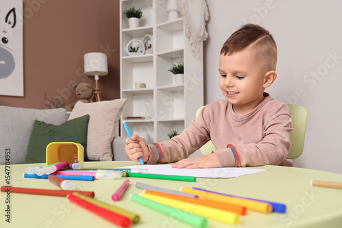 Funny little boy drawing wi...