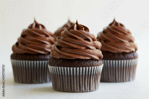 Chocolate cupcakes with chocolate frosting isolated on white background